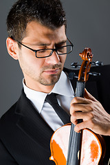 Image showing Musician with violin on dark background