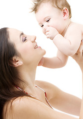 Image showing blue-eyed baby in mother hands