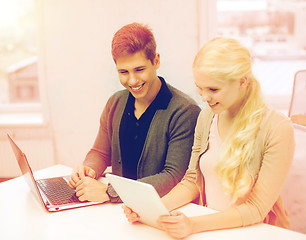 Image showing two teens with laptop and tablet pc at school