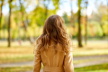 Image showing beautiful young woman walking in autumn park