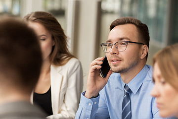 Image showing businessman calling on smartphone at office