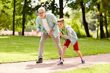 Image showing grandfather and grandson racing at summer park