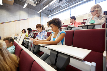 Image showing group of students with notebooks at lecture hall