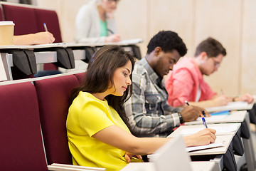 Image showing group of students with notebooks in lecture hall