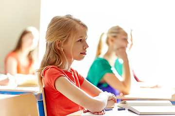 Image showing group of students with notebooks at school lesson