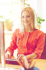 Image showing happy business woman with computer at office