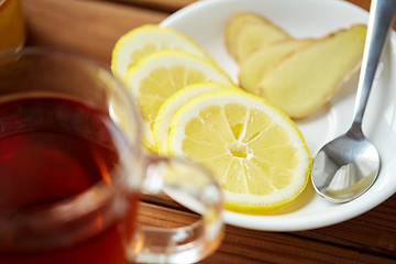 Image showing tea cup with lemon and ginger on plate