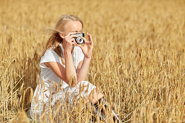 Image showing woman taking picture with camera in cereal field