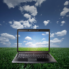 Image showing Laptop on green grass on a sunny day