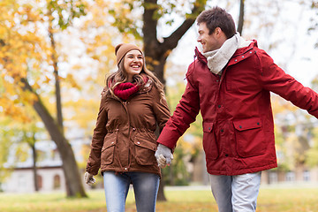 Image showing happy young couple walking in autumn park