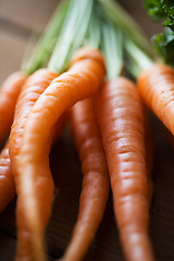 Image showing close up of carrot bunch on wooden table