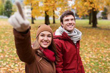 Image showing happy young couple walking in autumn park