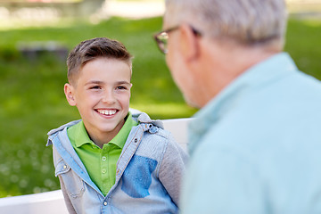 Image showing grandfather and grandson talking at summer park