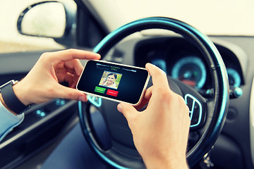 Image showing male hands with video call on smartphone in car