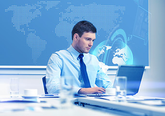 Image showing businessman with laptop working in office
