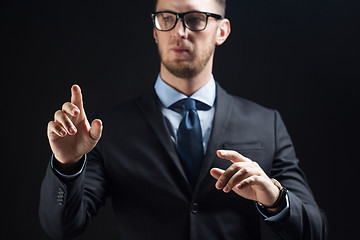 Image showing close up of businessman touching virtual screen