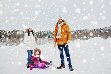 Image showing happy family with sled walking in winter outdoors