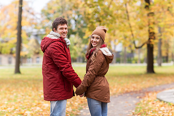 Image showing happy young couple walking in autumn park