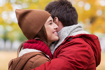 Image showing happy young couple hugging in autumn park