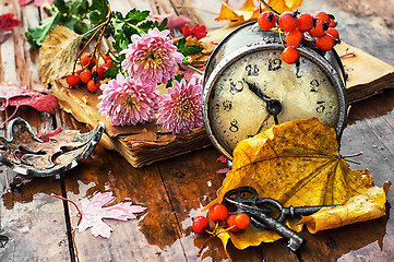 Image showing Alarm clock and fallen leaves