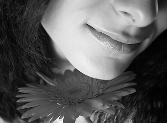 Image showing Girl with a red flower