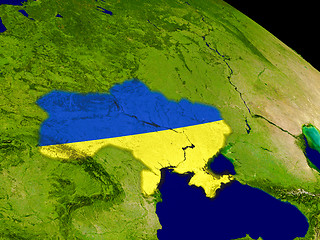 Image showing Ukraine with flag on Earth