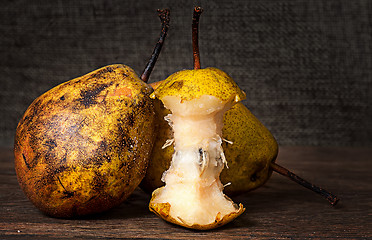 Image showing Two pears and stub standing on wooden table