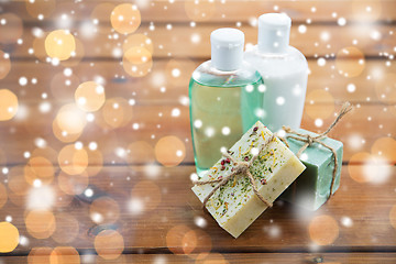 Image showing handmade soap bars and lotions on wood