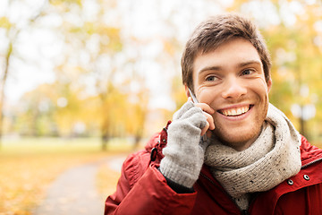 Image showing man with smartphone calling on city street