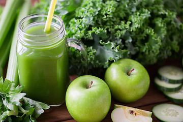 Image showing close up of jug with green juice and vegetables