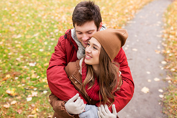 Image showing happy young couple hugging in autumn park