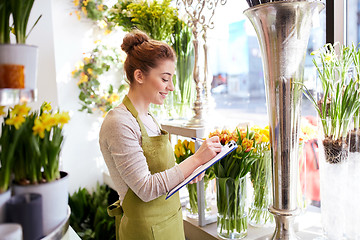 Image showing florist woman with clipboard at flower shop