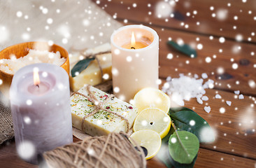 Image showing natural soap and candles on wood