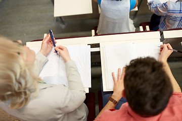 Image showing students with notebooks at exam or lecture