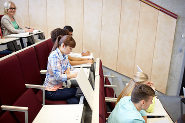 Image showing group of students with notebooks at lecture hall