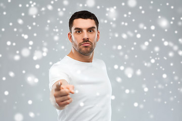 Image showing angry man pointing finger to you over snow