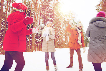 Image showing happy friends playing snowball in winter forest