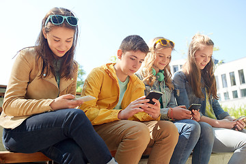 Image showing teenage friends with smartphone and headphones