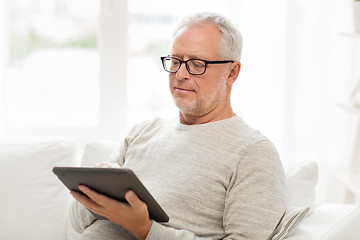 Image showing senior man with tablet pc at home