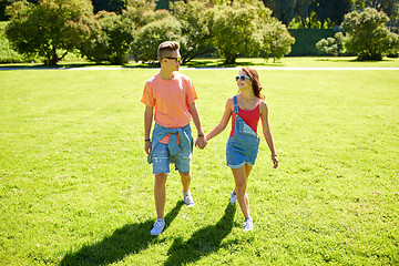 Image showing happy teenage couple walking at summer park