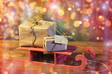 Image showing close up of christmas gift boxes on wooden sleigh