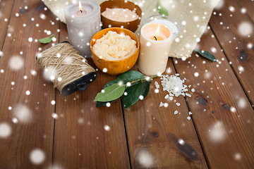 Image showing natural body scrub and candles on wood