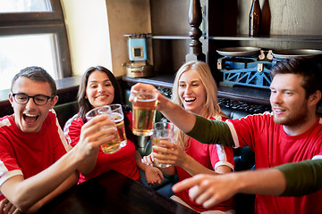 Image showing football fans clinking beer glasses at sport bar