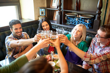 Image showing happy friends drinking beer at bar or pub