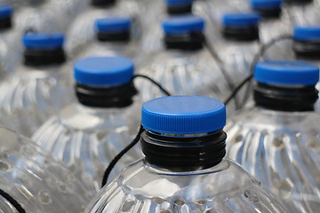 Image showing  plastic bottles with blue lids 