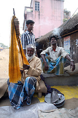 Image showing Portrait of a fisherman who weaves a fishing net before the next fishing in Kumrokhali, India