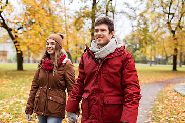 Image showing happy young couple walking in autumn park