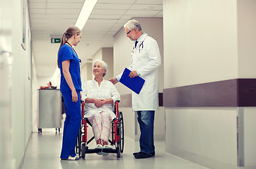 Image showing medics and senior woman in wheelchair at hospital