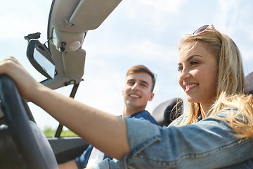 Image showing happy couple driving in cabriolet car outdoors