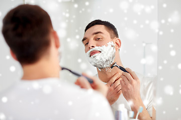 Image showing man shaving beard with razor blade at bathroom